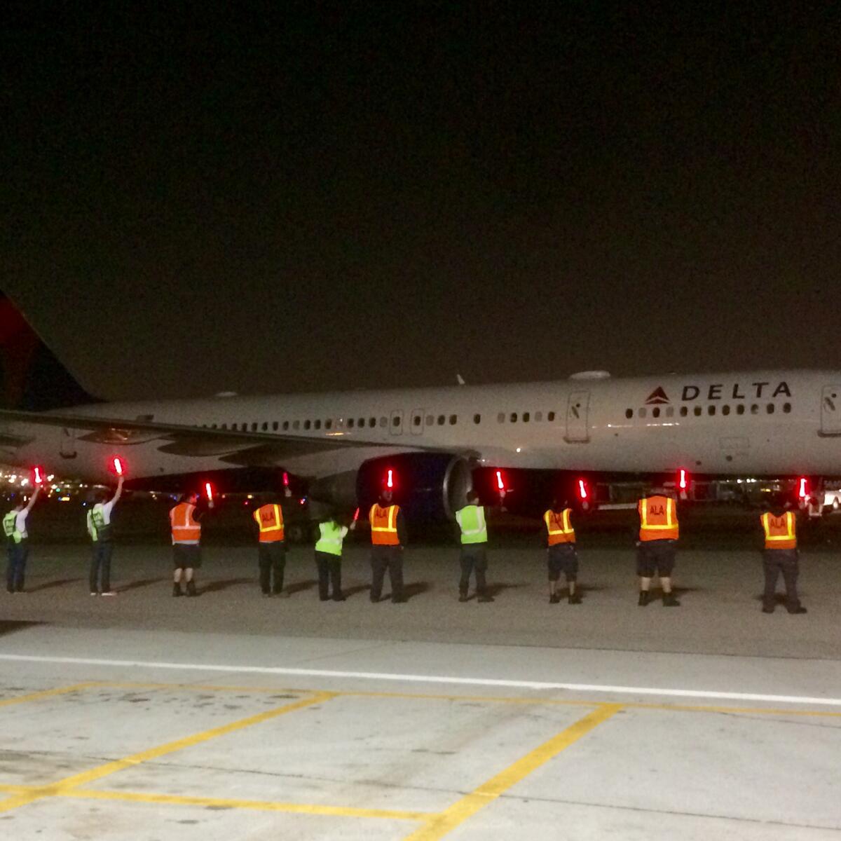 Delta employees usher in the first flight to Delta's new home at LAX during the airline's large terminal move that began in 2017.