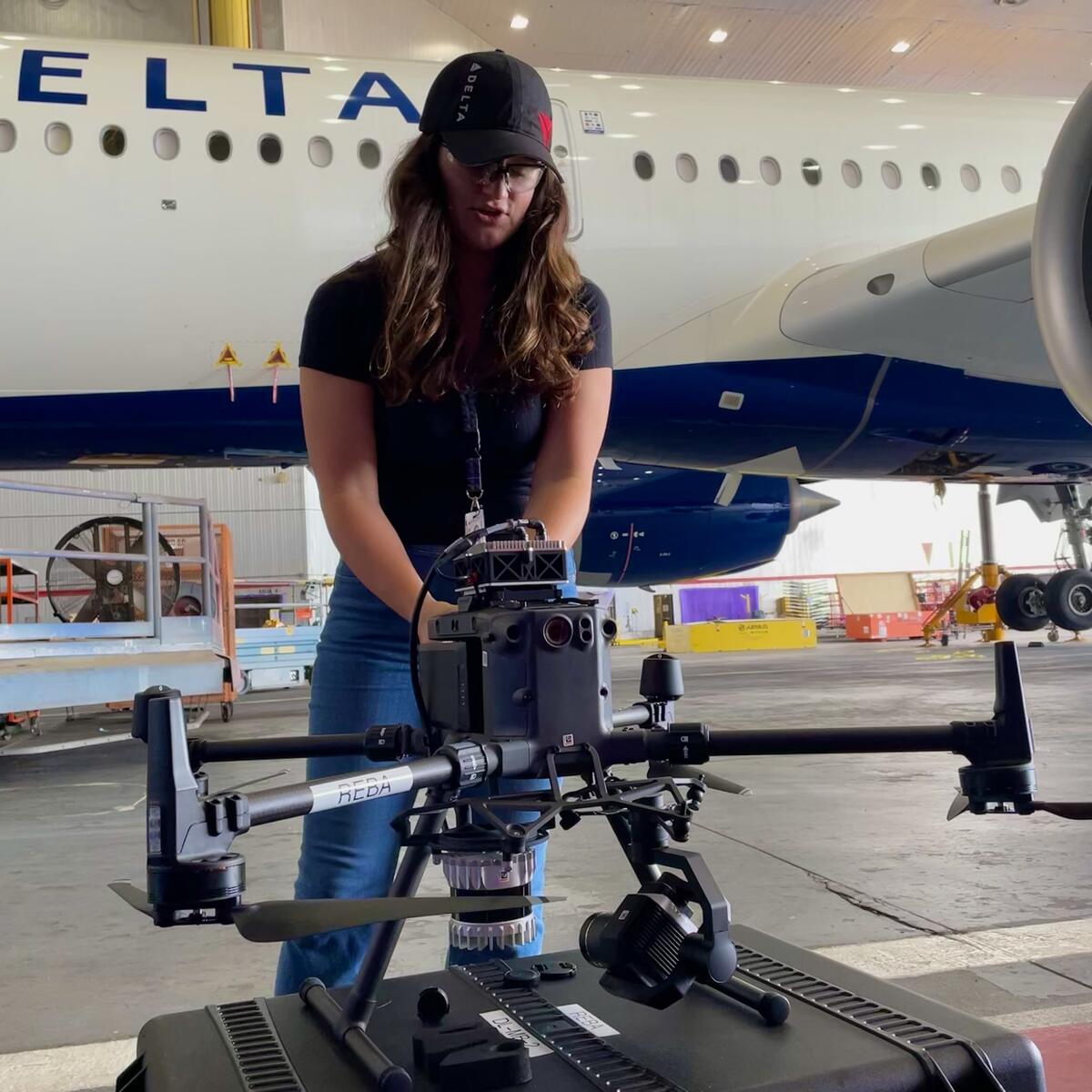 Emma Galarza, a senior engineer with Delta TechOps, prepares an autonomous drone for flight.