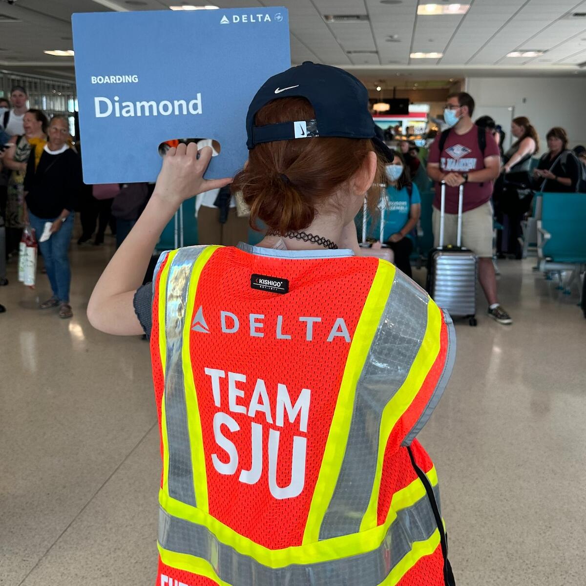 A child holds up a boarding sign at San Juan Airport as part of a special initiative to inspire excitement about aviation. 