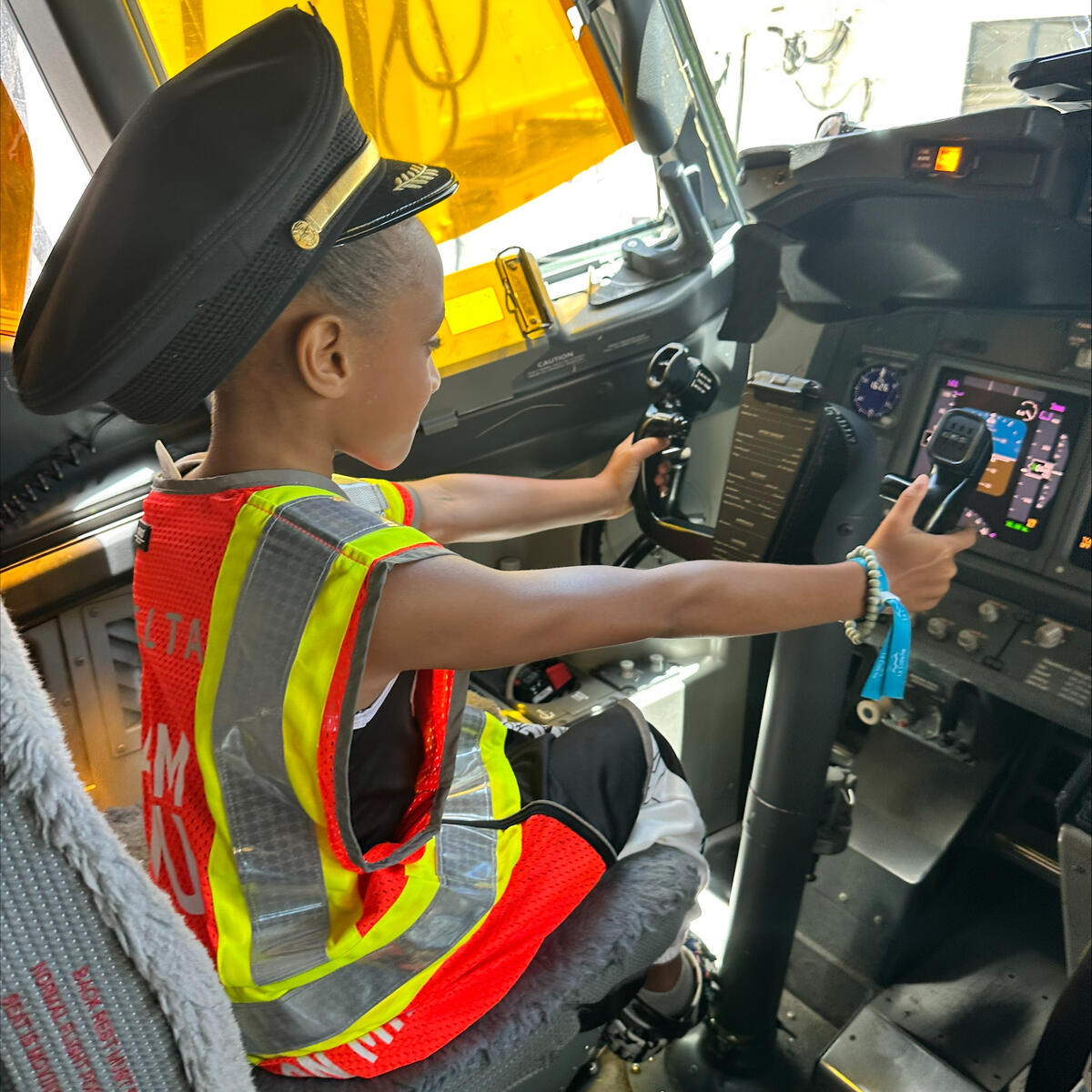A child sits in the flight deck on an aircraft at San Juan Airport as part of a special initiative to inspire excitement about aviation.