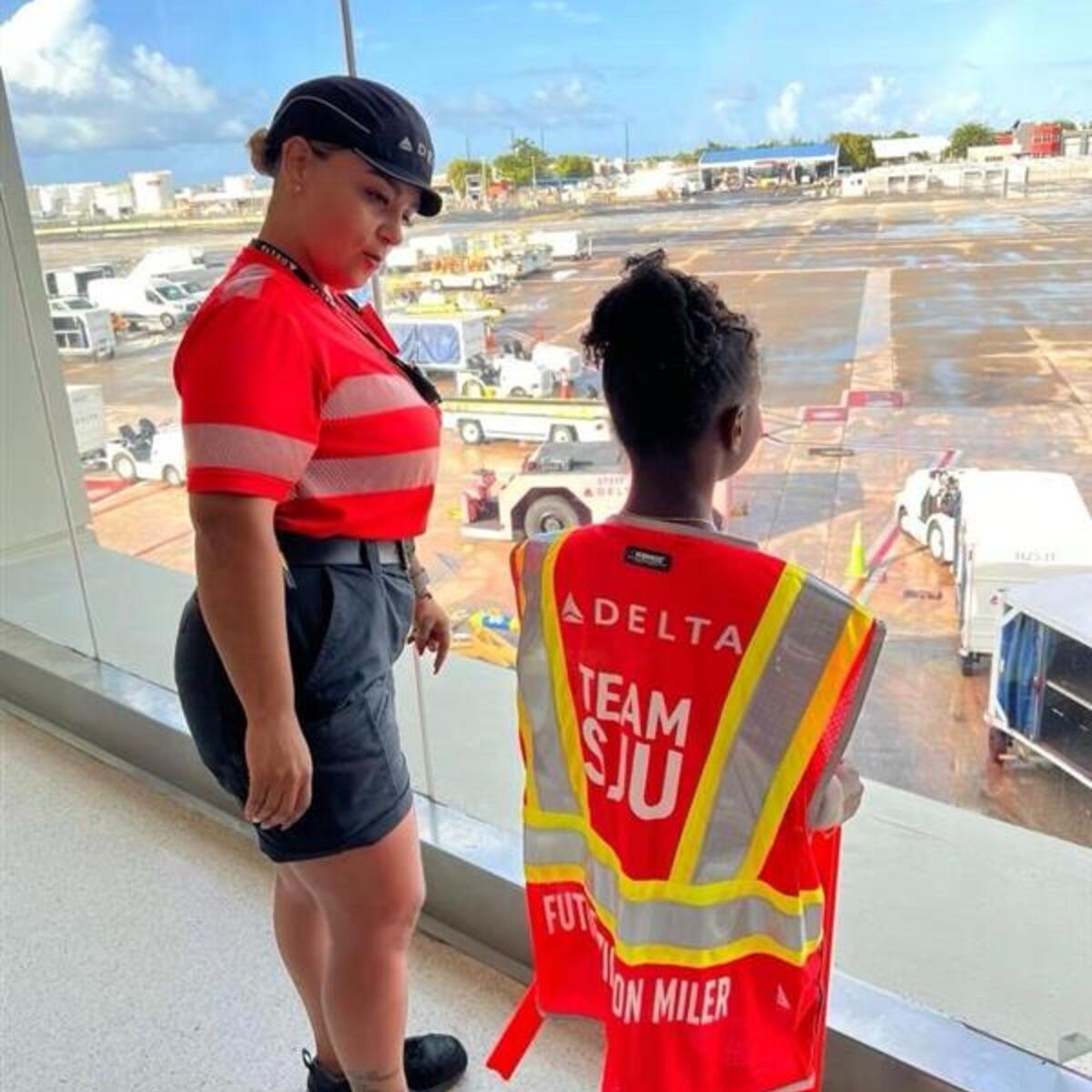 A Delta employee talks to a child at San Juan Airport as part of a special initiative to inspire excitement about aviation.