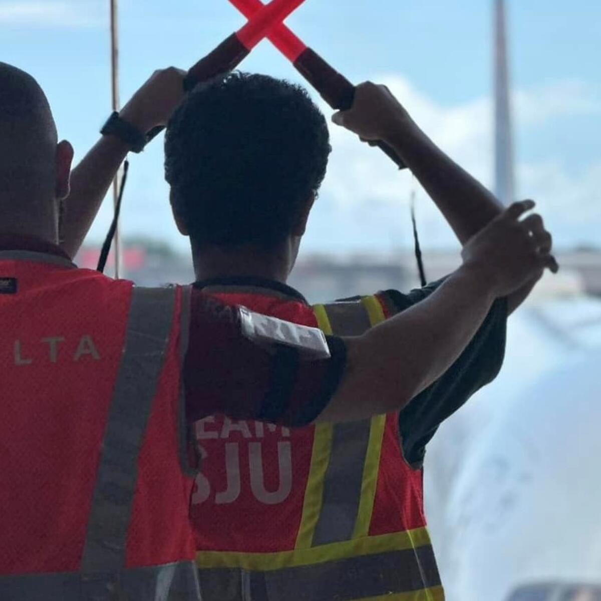 A Delta employee works with a child at San Juan Airport as part of a special initiative to inspire excitement about aviation.