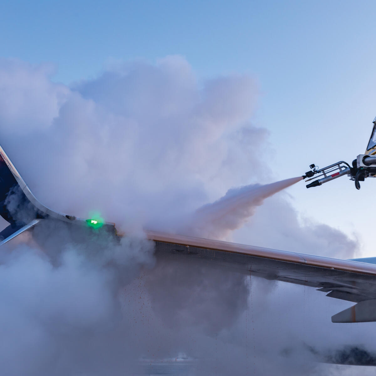 Delta crews de-ice a Boeing 737 at Minneapolis-Saint Paul International Airport.