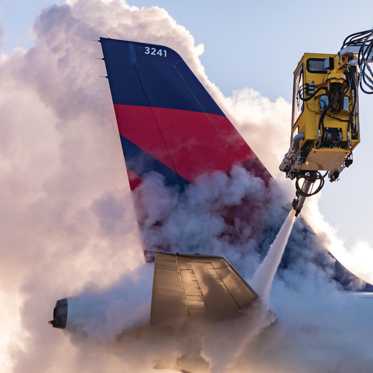 Deicing the tail of an Airbus A320 at Minneapolis-Saint Paul International Airport.