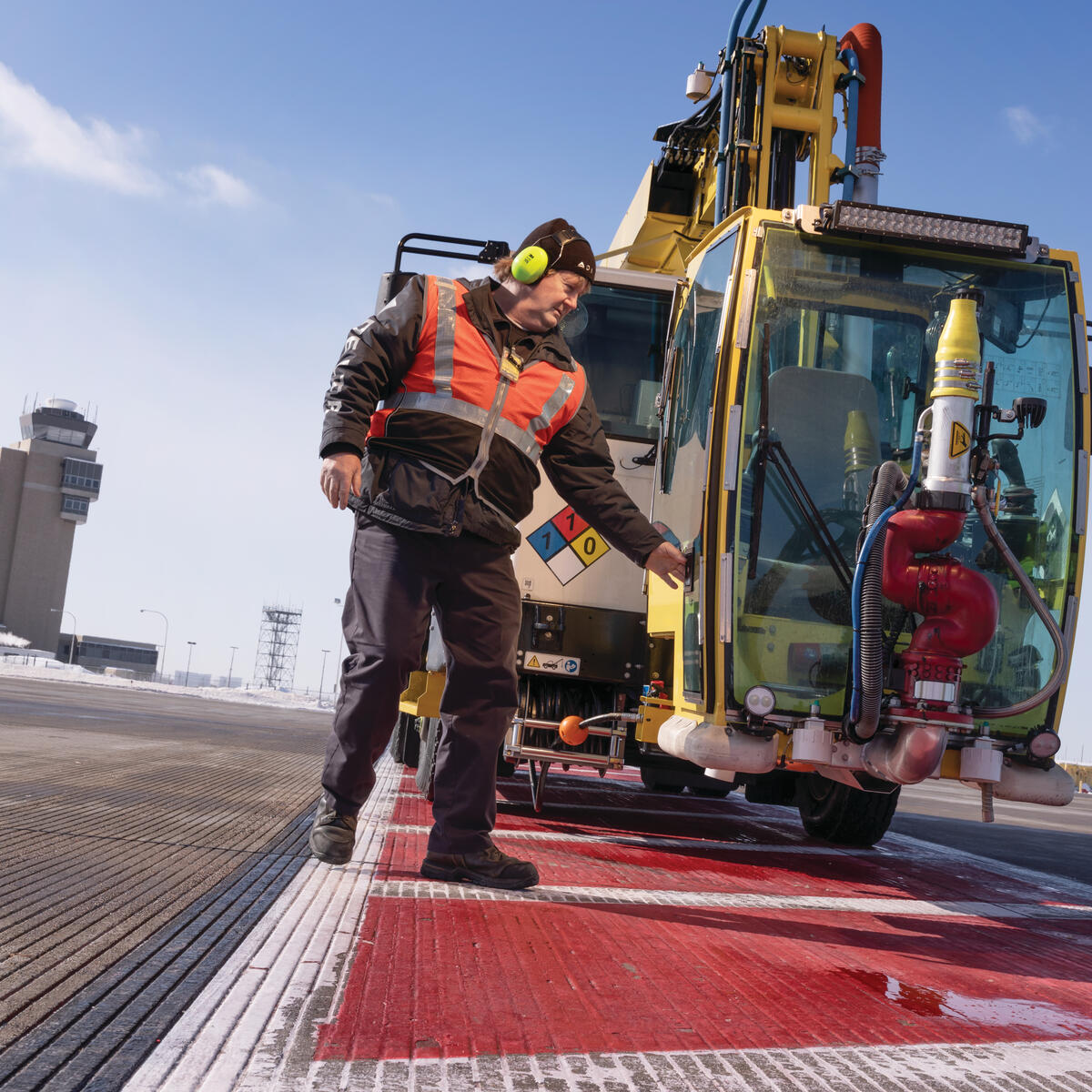 Ramp Agent Bruce Torseth prepares to de-ice aircraft at Minneapolis-St. Paul International Airport.