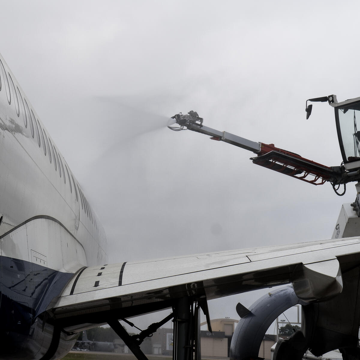 A mock deicing of plane in MSP for Delta's deicing summer boot camp