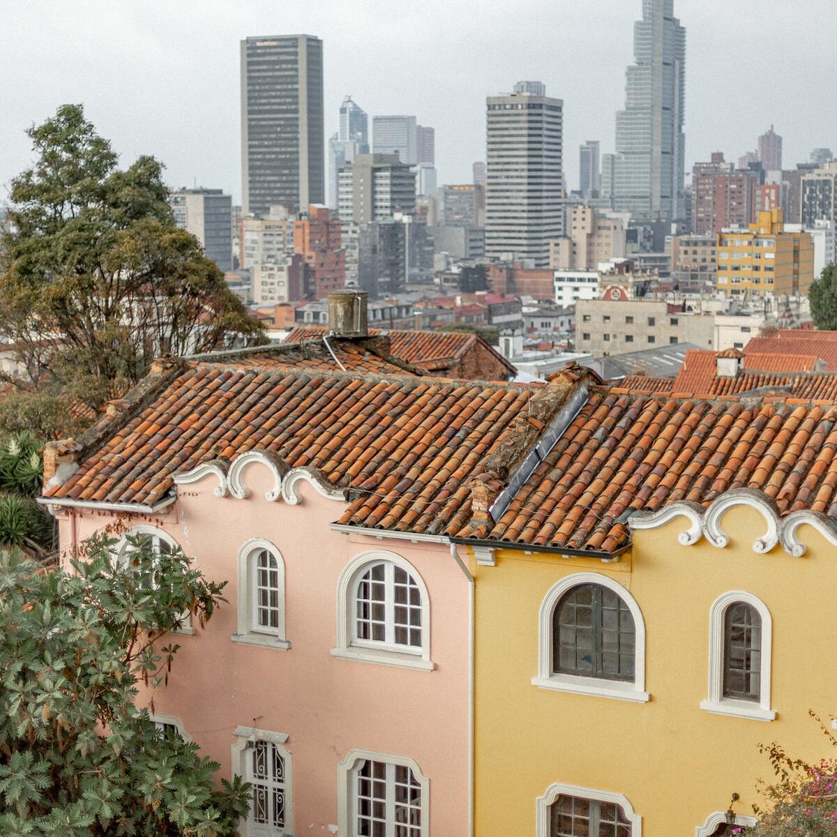 Old houses with new skyscrapers in the background in Bogota, Colombia