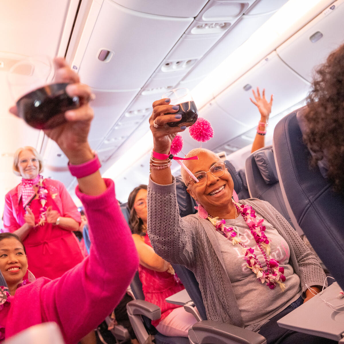 Delta people onboard the Breast Cancer One charter flight raise a toast.