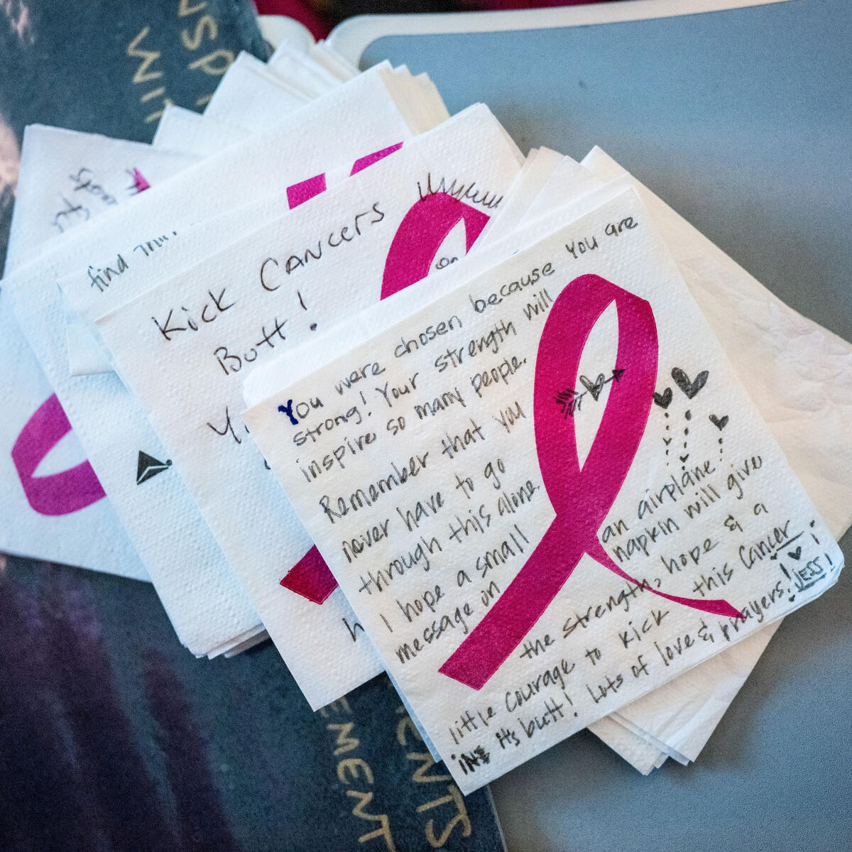 As part of the Breast Cancer One charter flight experience, notes were written on napkins to breast cancer survivors and fighters.