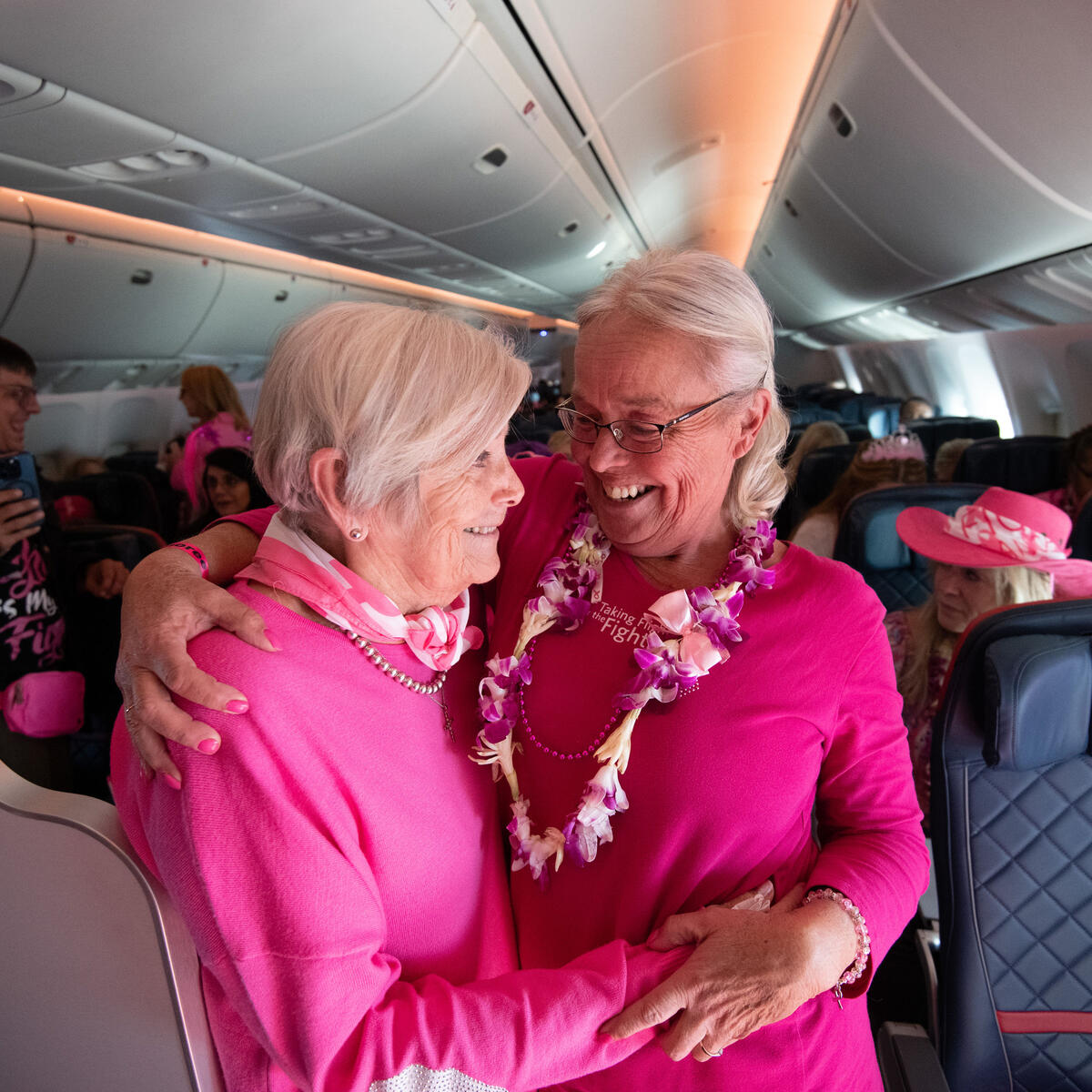 Two breast cancer survivors who joined Delta's Breast Cancer One charter flight hug.
