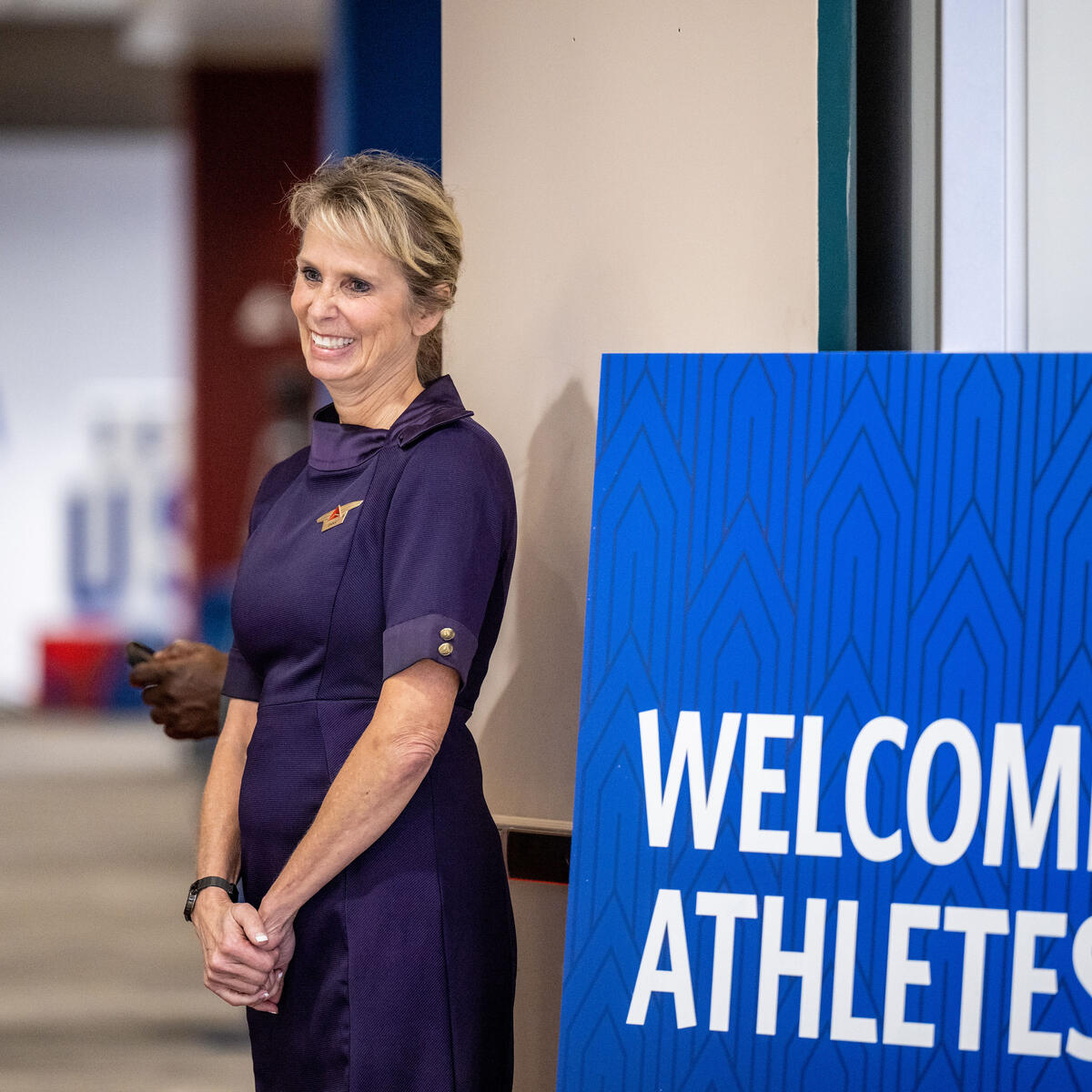 A Delta flight attendant welcomes Team USA athletes to Delta's customized athlete lounge in the ATL International Terminal.