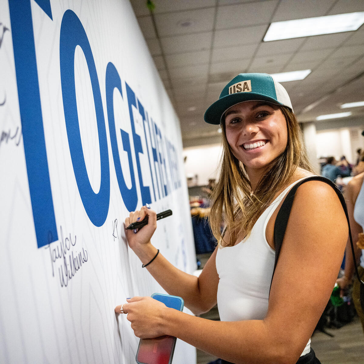 Team USA athletes sign the wall in Delta's customized athlete lounge in the ATL International Terminal.