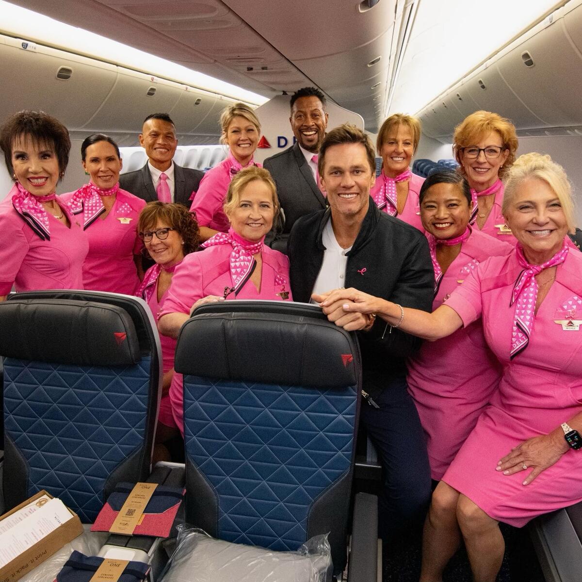 Tom Brady poses with Delta people on board the Breast Cancer One charter flight.