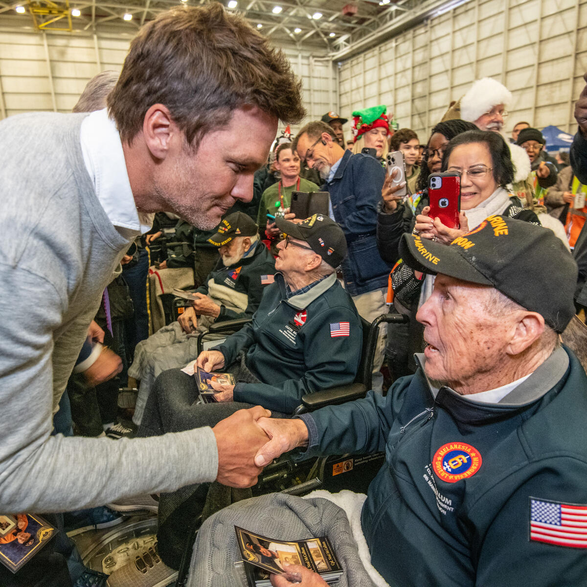 Tom Brady, a seven-time Super Bowl champion, shakes hands with a U.S. military veteran at Delta's 12th annual Veterans Celebration.