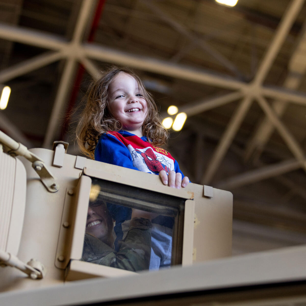 A kid enjoys one of many plane displays at Delta's 12th annual Veterans Celebration.
