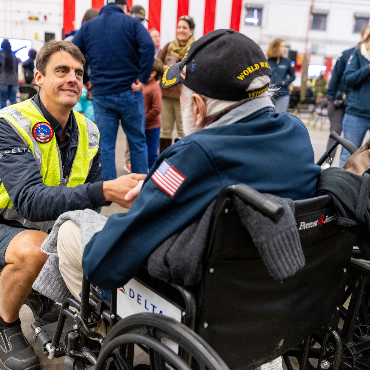 A Delta TechOps employee shakes hands with a U.S. military veteran at Delta's 12th annual Veterans Celebration.