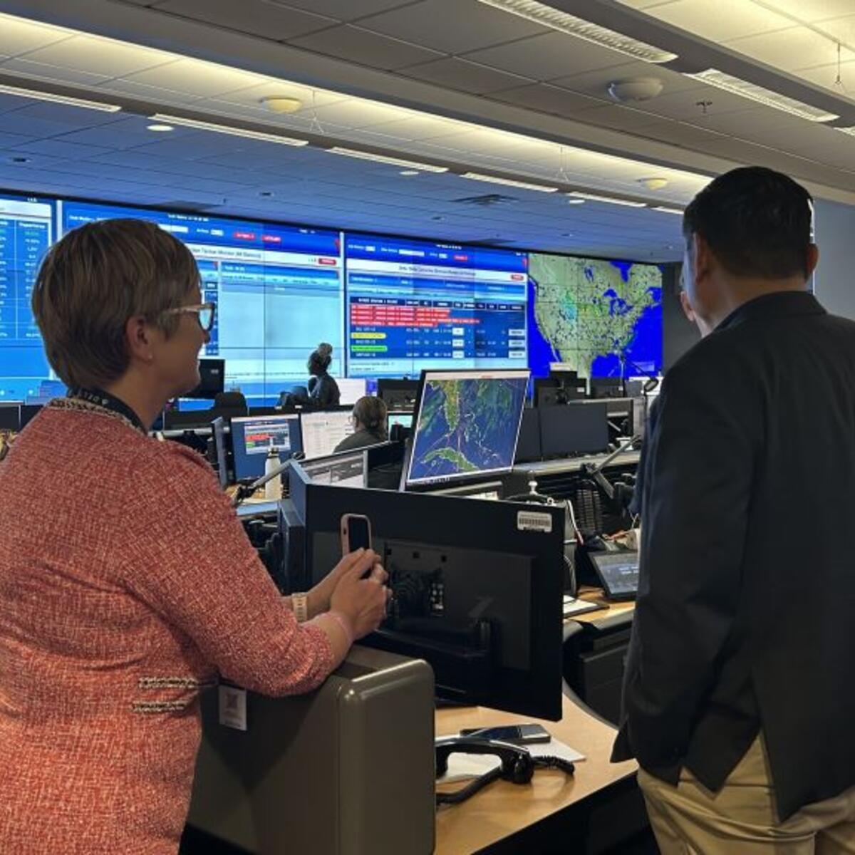 A Delta employee shows Todd O., Delta's most frequent flyer, around the OCC, the heartbeat of the operation with constant flight, emergency and weather tracking. 