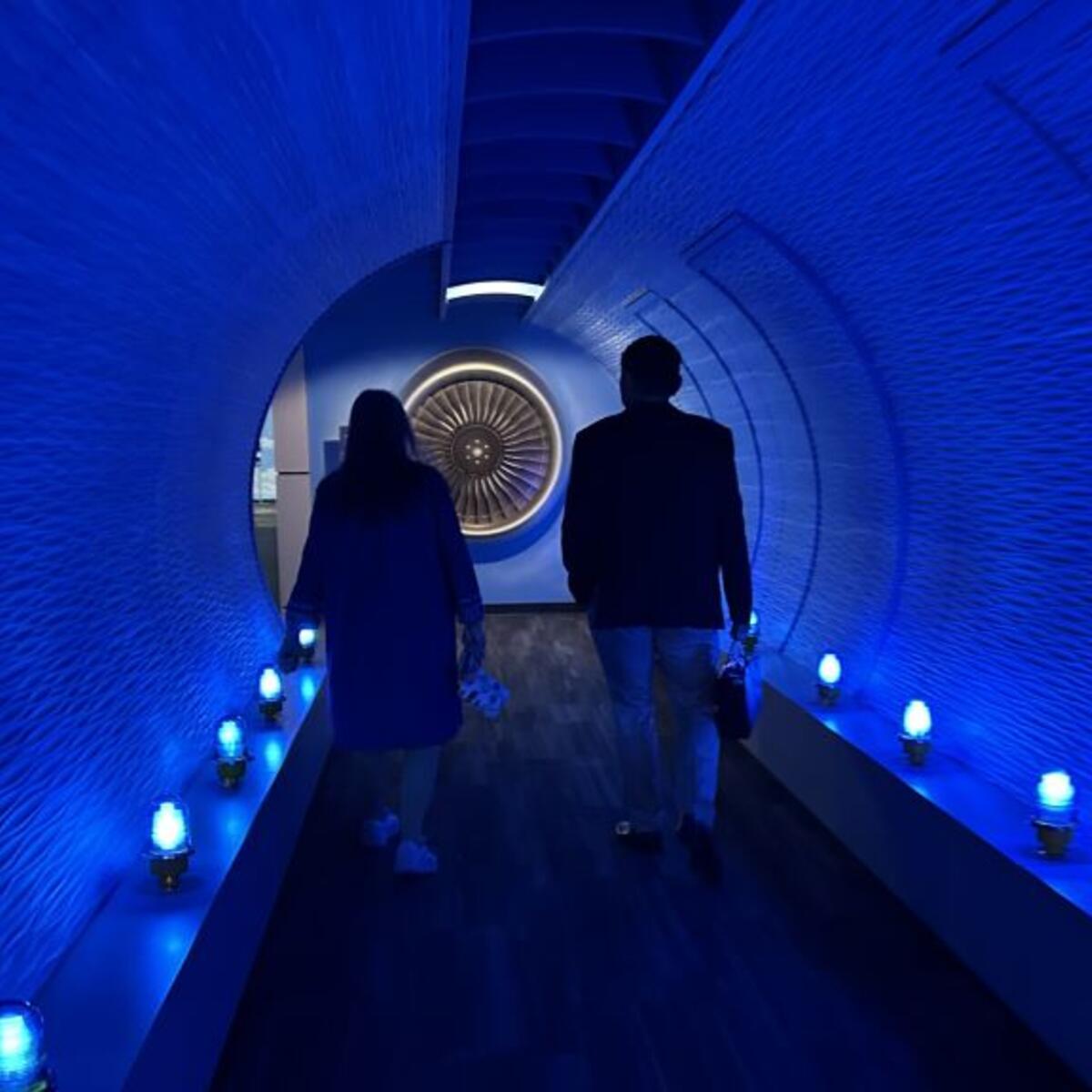 Todd O., Delta's most frequent flyer, and a Flight Museum employee walk through the breezeway before touring the Boeing 767 Spirit of Delta on the other side. 