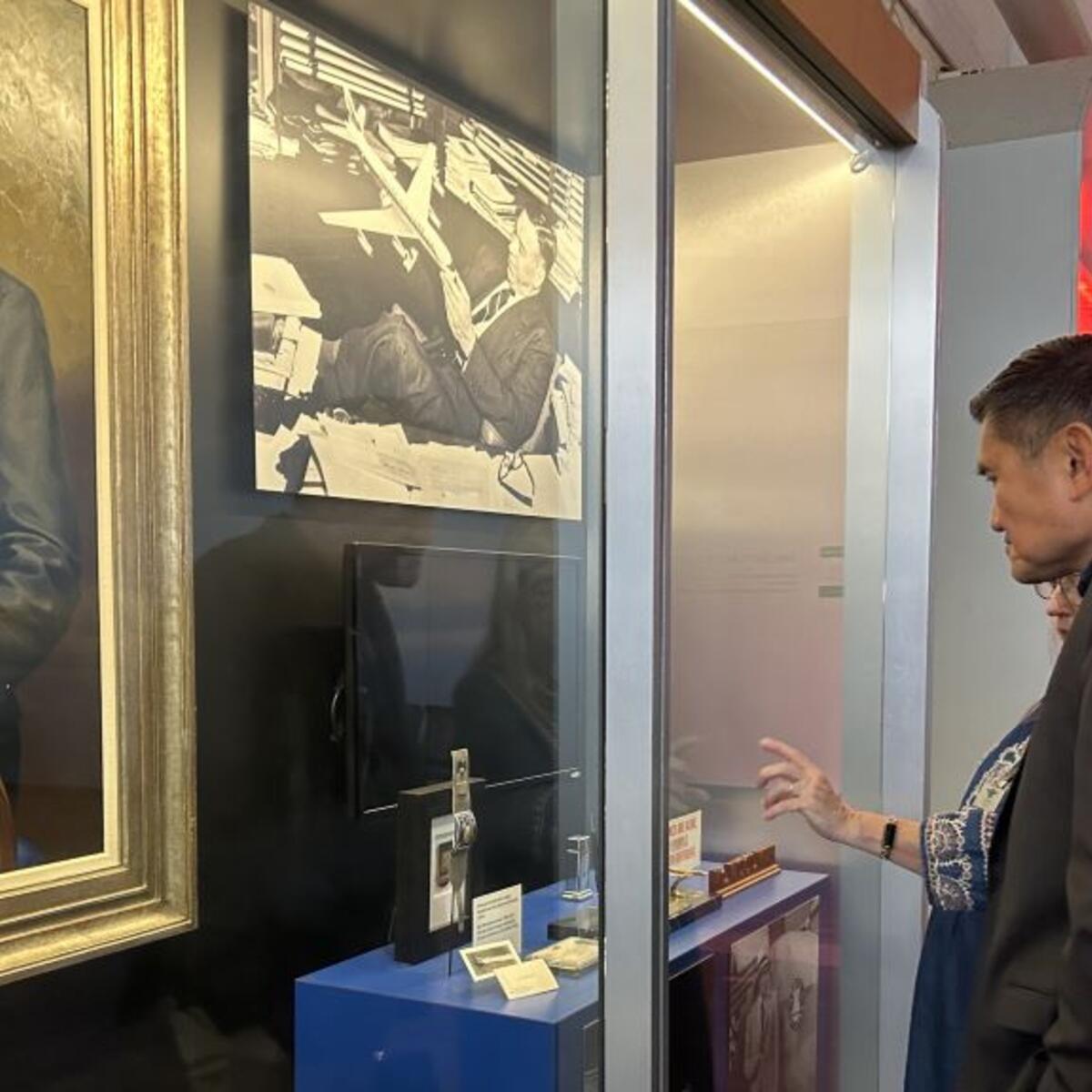 A Delta Flight Museum employee walks Todd O., Delta's most frequent flyer, through the aviation capsule collection featuring founder C.E. Woolman’s most treasured belongings. 
