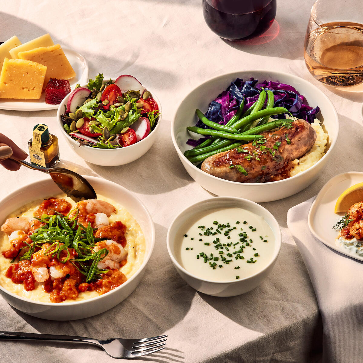 Delta One customers flying international on select flights may want to indulge in Chef Bailey’s creole shrimp with creamy grits and tomato gravy. Also available: Grilled bratwurst with braised red cabbage, herb mashed potatoes, green beans and a grain mustard demi-glace; cauliflower soup with a snipped-chives garnish; poached shrimp appetizer with cucumber yogurt sauce and lemon; and a side salad of mixed greens with radish, tomatoes and balsamic vinaigrette.