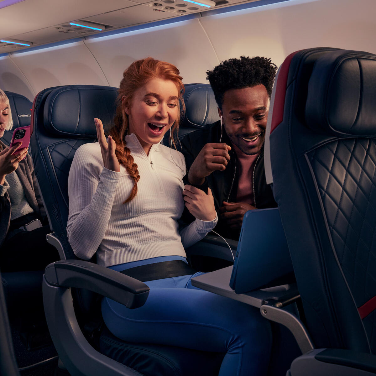 Delta customers watch a tablet on-board using Delta's fast, free Wi-Fi.