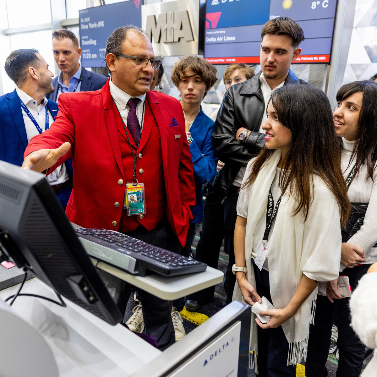 A Red Coat walks New Worl School of the Arts students through a "day in the life" at Miami International Airport as part of Delta and LATAM's Job Shadow Day.