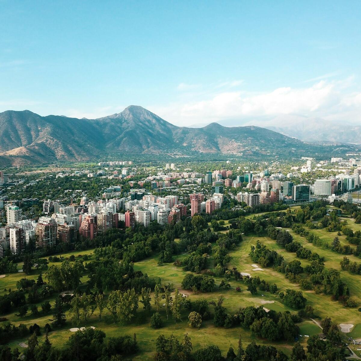 A scenic view of Santiago, Chile with mountains behind a city