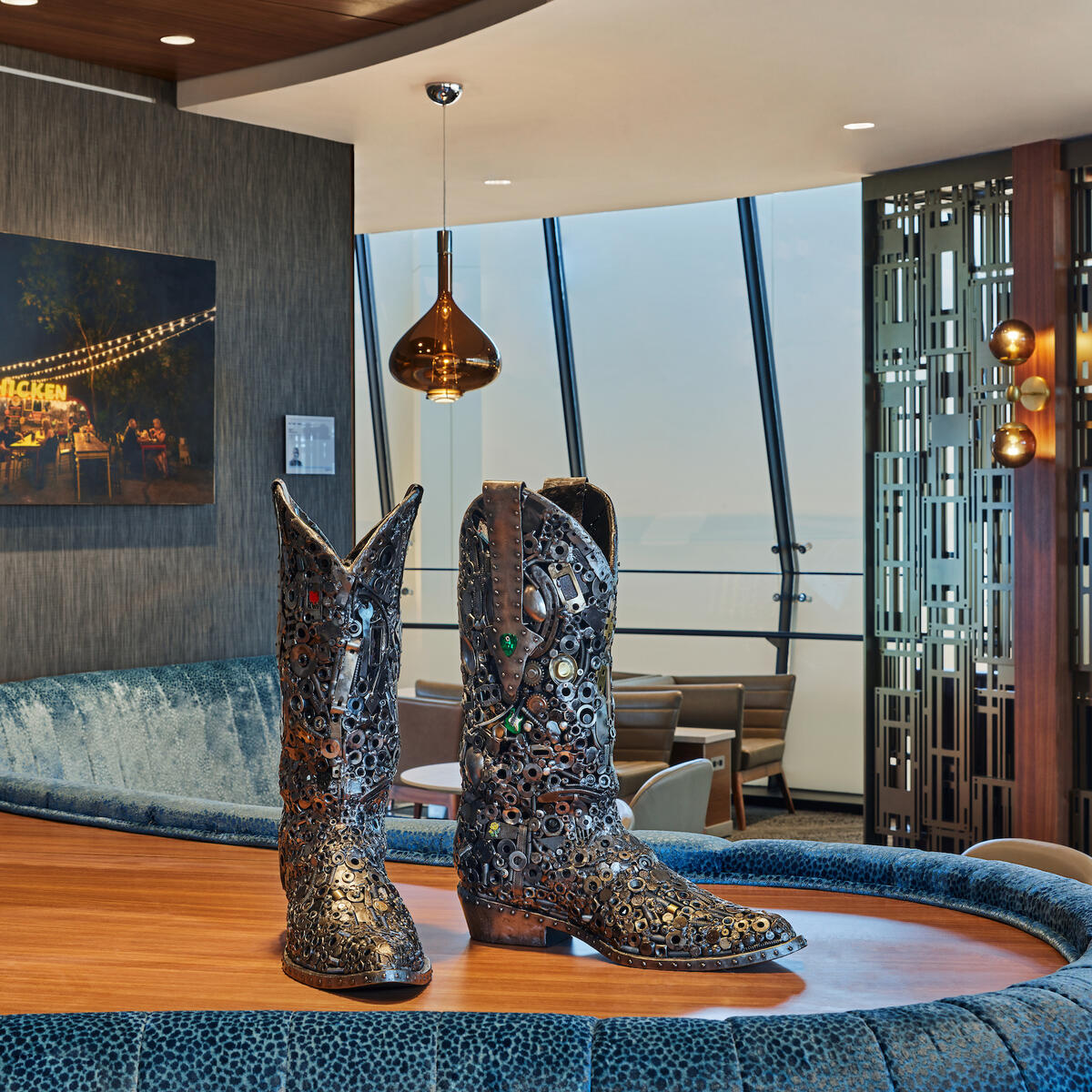 A pewter rhinestone cowboy boot sculpture sits in the Delta Sky Club in Austin, Texas.