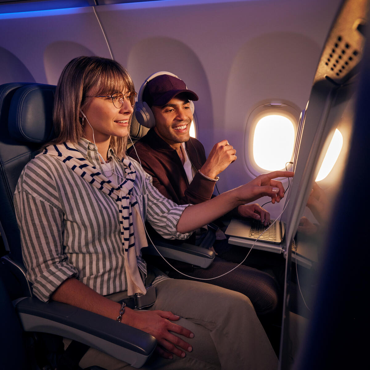Customers browse seatback entertainment on a Delta flight.
