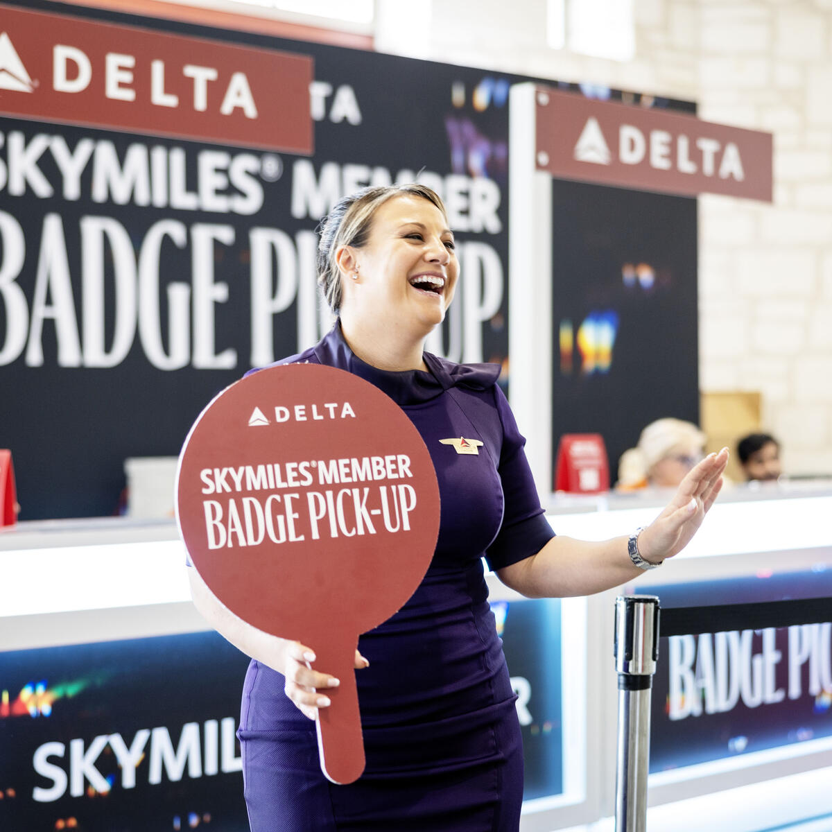 Austin-based flight attendants and Red Coats assist in assisting guests with a dedicated badge pick-up area for SkyMiles Members at the Austin Convention Center Rotunda Foyer during SXSW 2024.