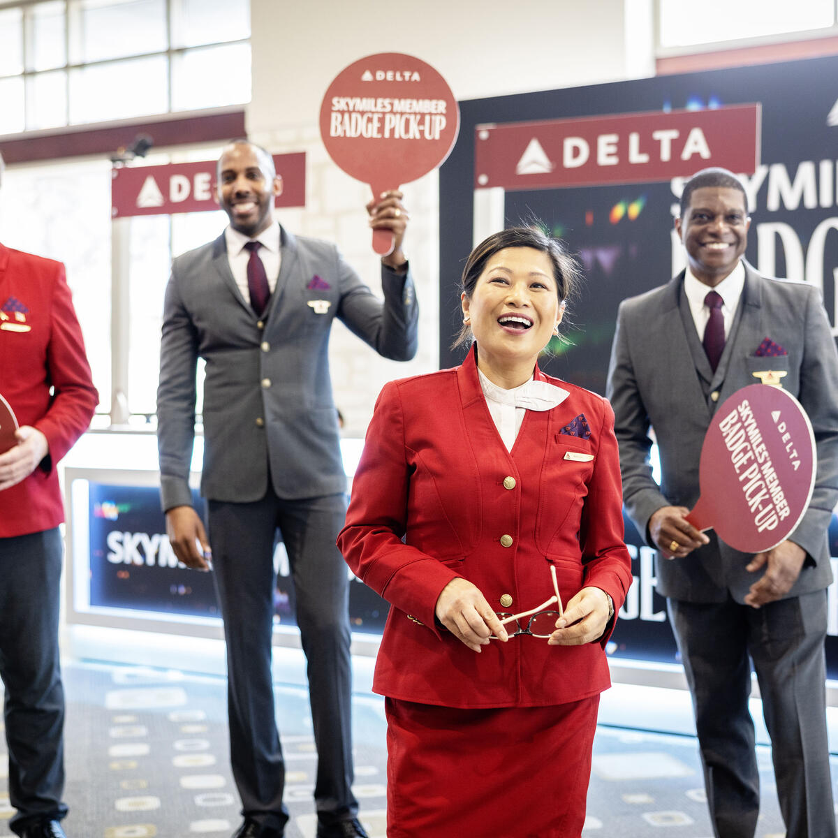 Austin-based flight attendants and Red Coats assist in assisting guests with a dedicated badge pick-up area for SkyMiles Members at the Austin Convention Center Rotunda Foyer during SXSW 2024.