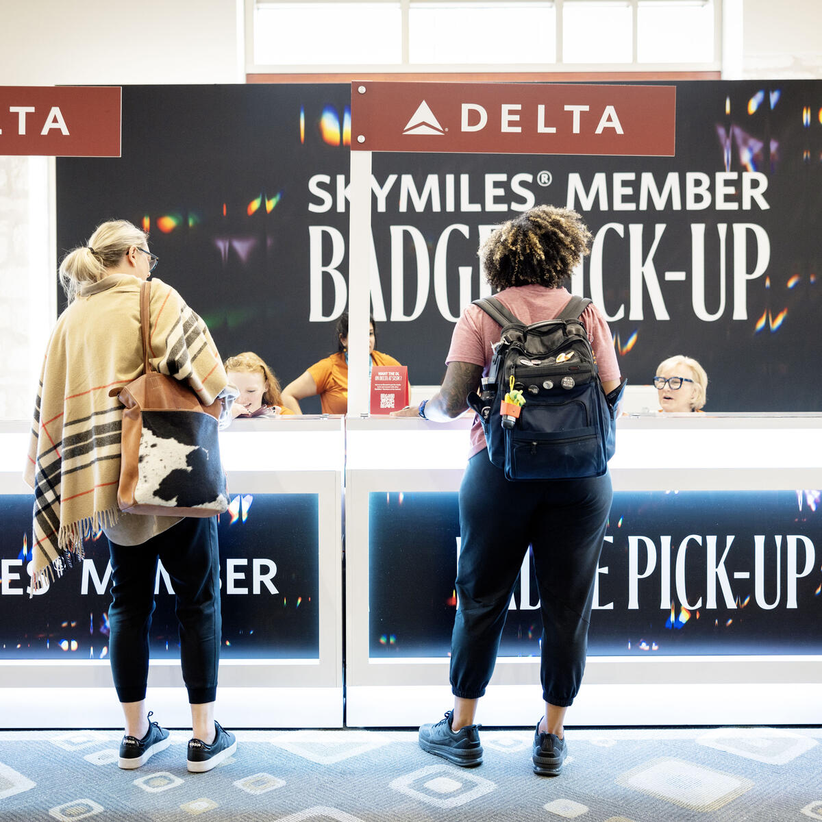 Visitors approach the expedited SkyMiles Member Badge Pick-Up at the Austin Convention Center Rotunda Foyer during SXSW 2024.
