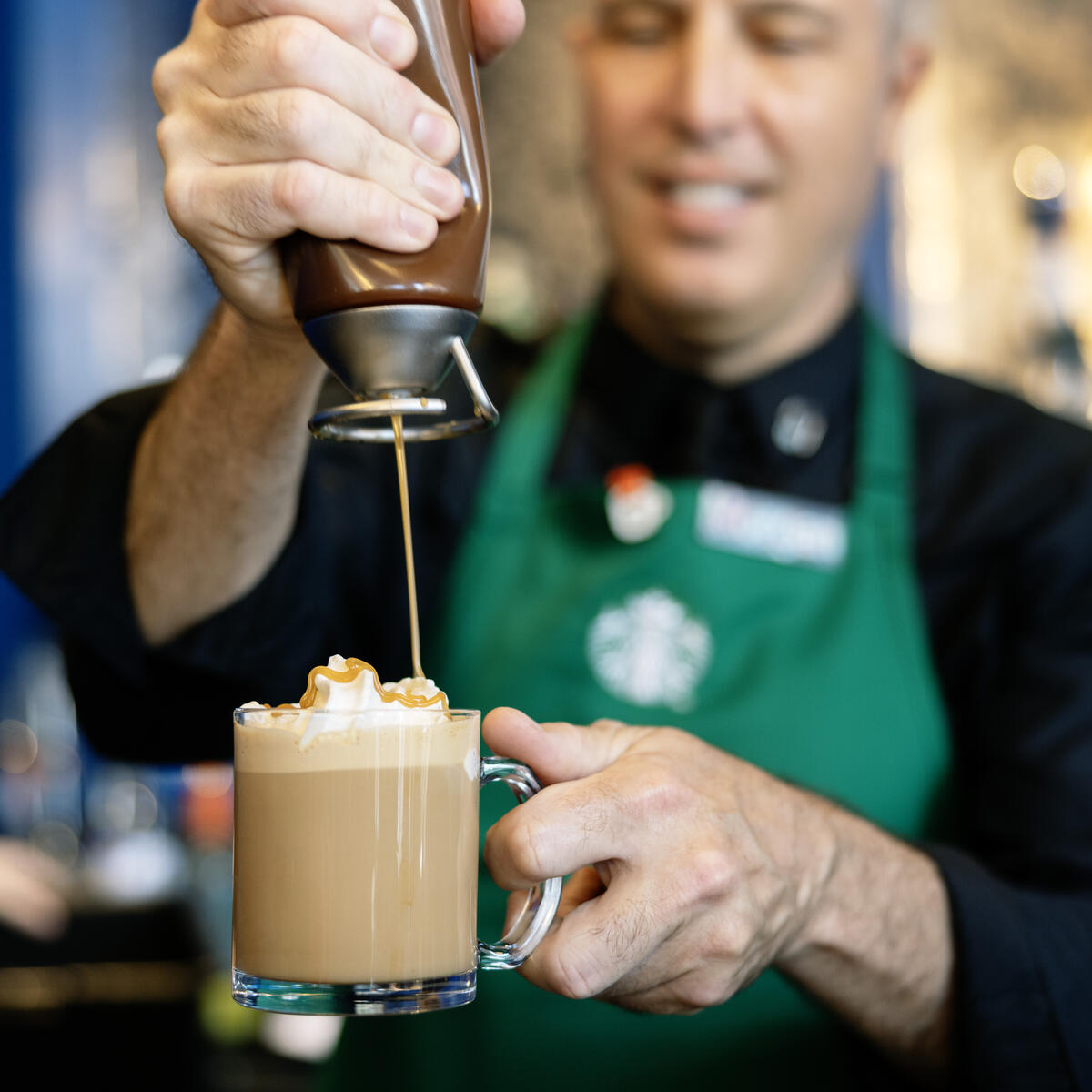 A Starbucks barista in the Delta Lounge prepares a specialty Dulce de Leche latte, a flavor exclusive to Latin American Starbucks locations.