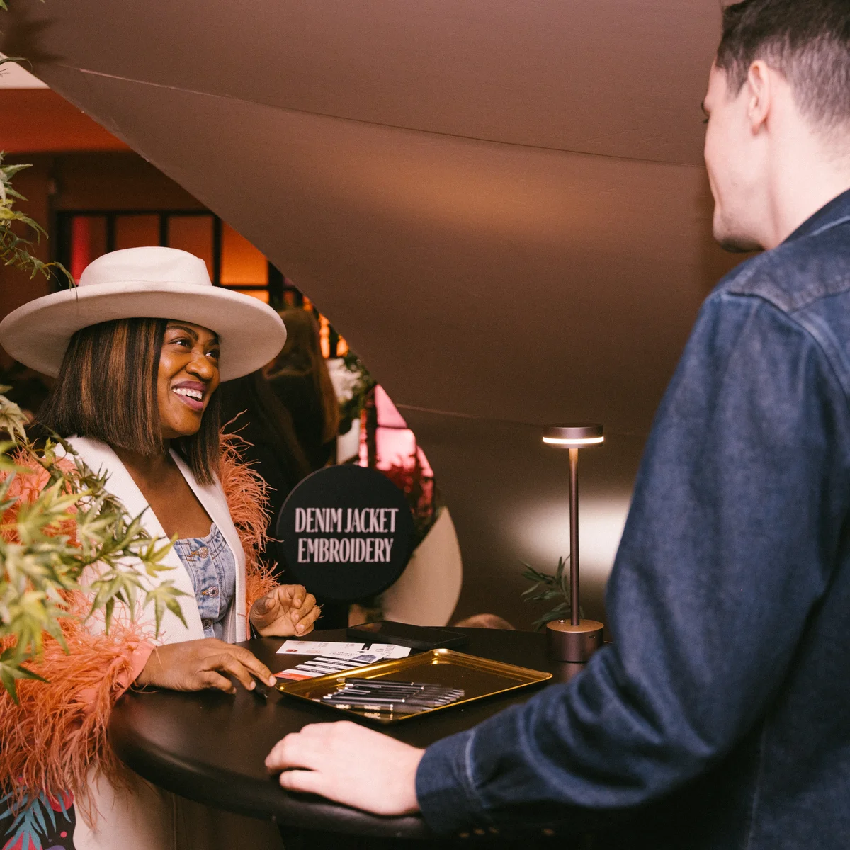 A SkyMiles member checks into the Denim Jacket Embroidery Station at Delta's SXSW lounge.&nbsp;