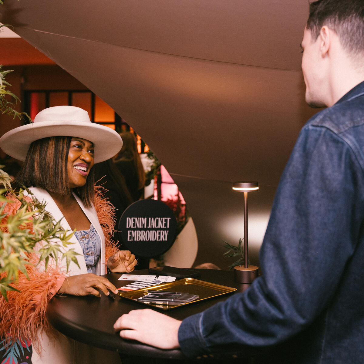 A SkyMiles member checks into the Denim Jacket Embroidery Station at Delta's SXSW lounge.&nbsp;