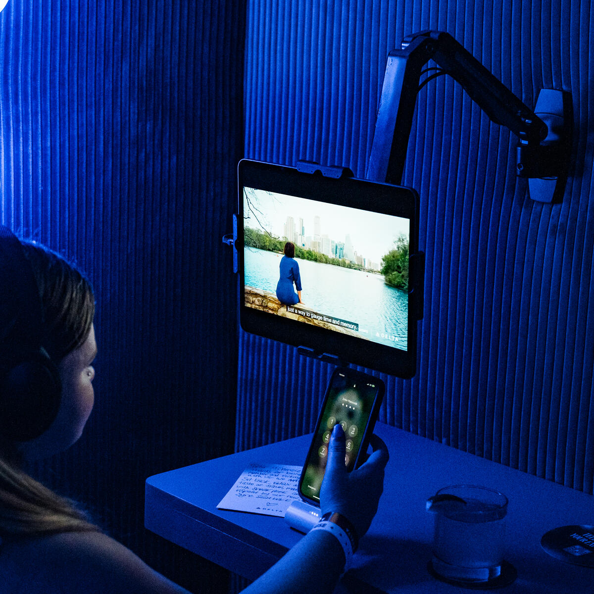 A SkyMiles member enjoys locally curated content in the Delta Sync space, an experience designed to recall Delta’s seatback in-flight entertainment screens and Fast, Free Wi-Fi powered by T-Mobile.