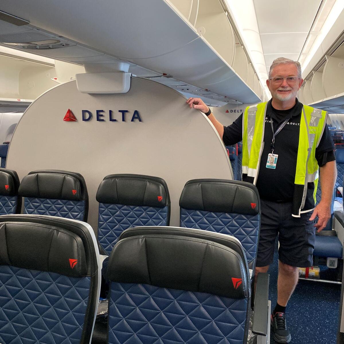 Tracy Rawls, Lead Aviation Maintenance Technician on the Delta TechOps Cabin Maintenance Team, stands on board an airplane.