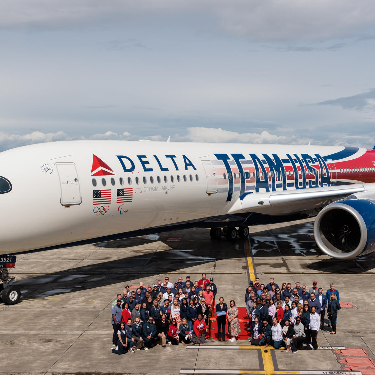 Delta's Chairman's Club Honorees pose with Delta's custom Airbus A350 Team USA aircraft.