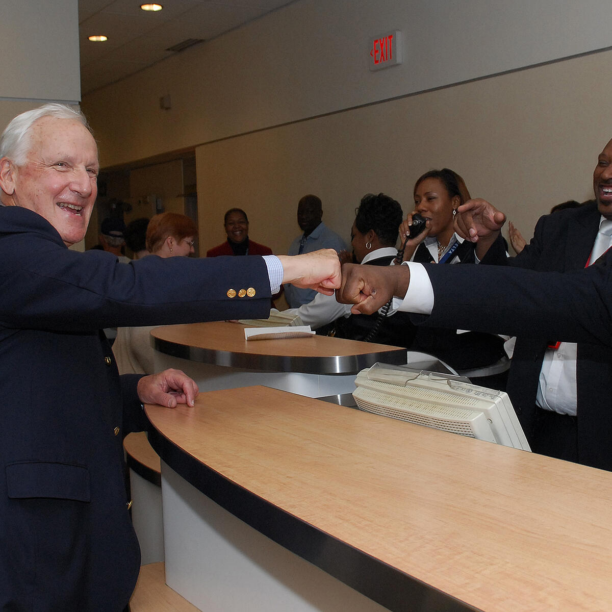 Former Delta CEO Jerry Grinstein bumps fists with Delta Gate Agents.