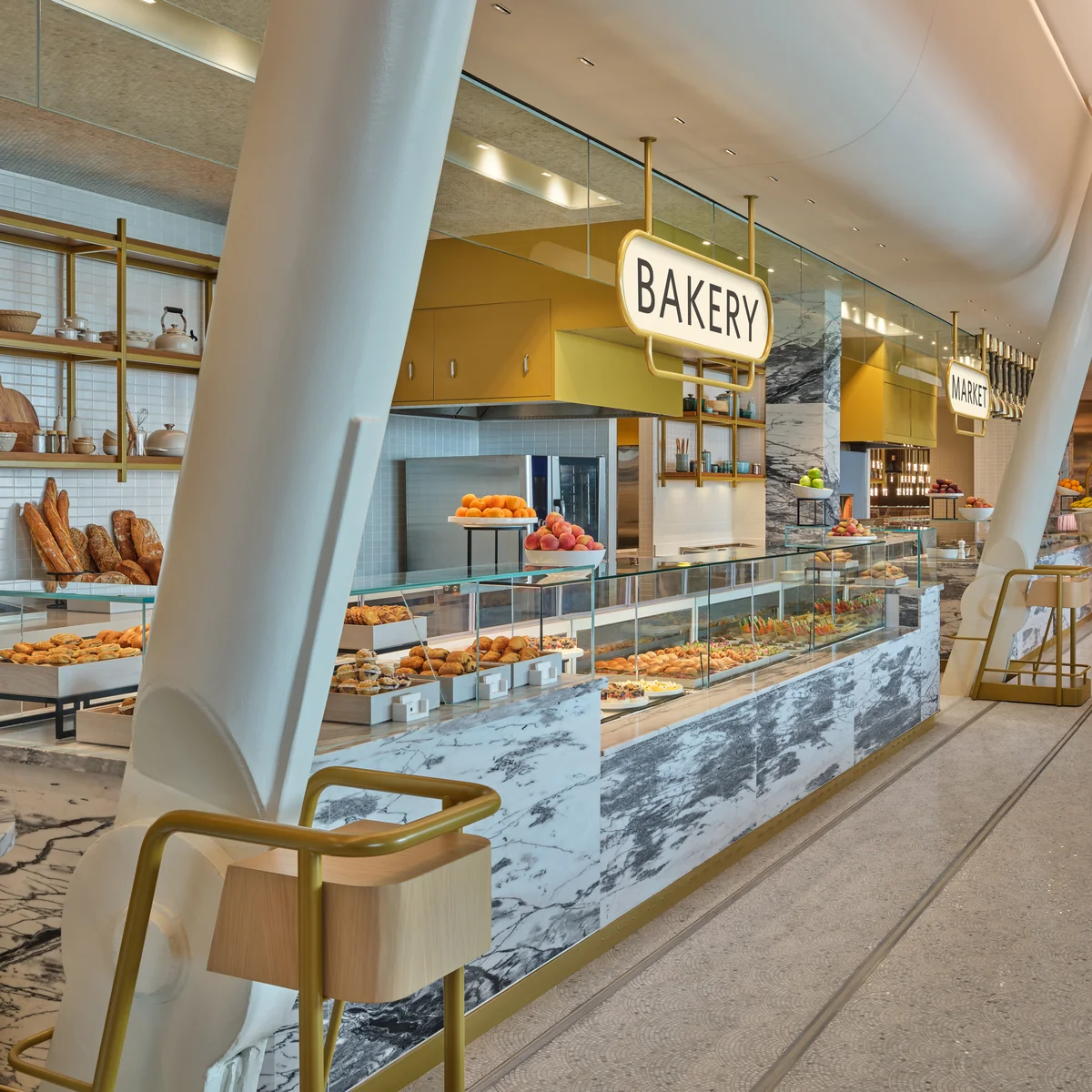Fan-shaped marble mosaic tiles in the Market dining area at The Delta Lounge-JFK pay tribute to famed New York brasseries. The penny-round ceiling over the food counter is a hat-tip to the original JFK terminal, designed by famed architect Eero Saarinen.
