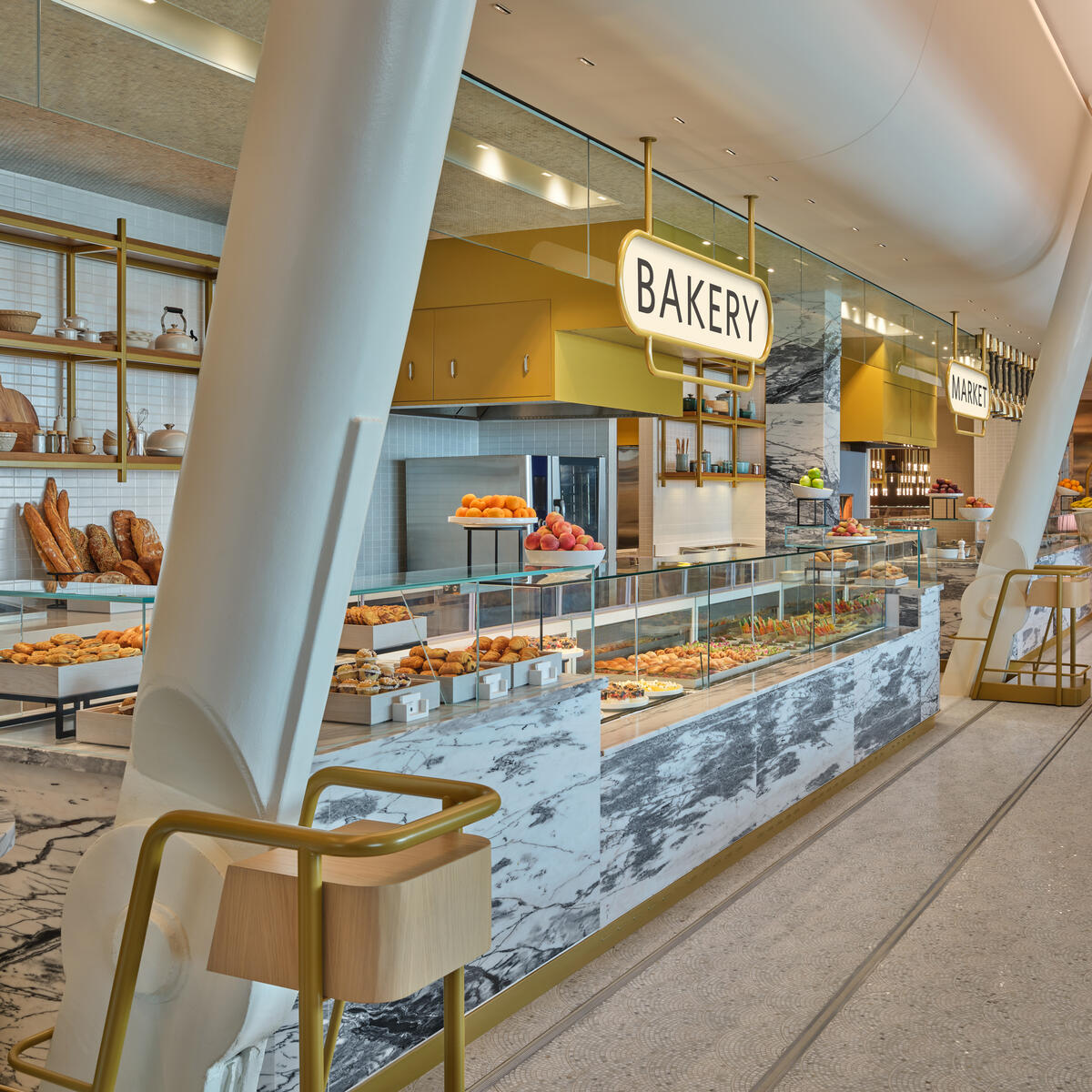 Fan-shaped marble mosaic tiles in the Market dining area at The Delta Lounge-JFK pay tribute to famed New York brasseries. The penny-round ceiling over the food counter is a hat-tip to the original JFK terminal, designed by famed architect Eero Saarinen.