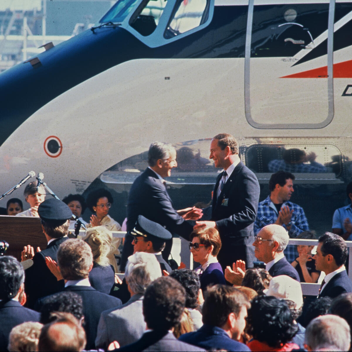 Former Delta CEO Jerry Grinstein stands before a crowd at the merger of Delta and Western Airlines in 1987.