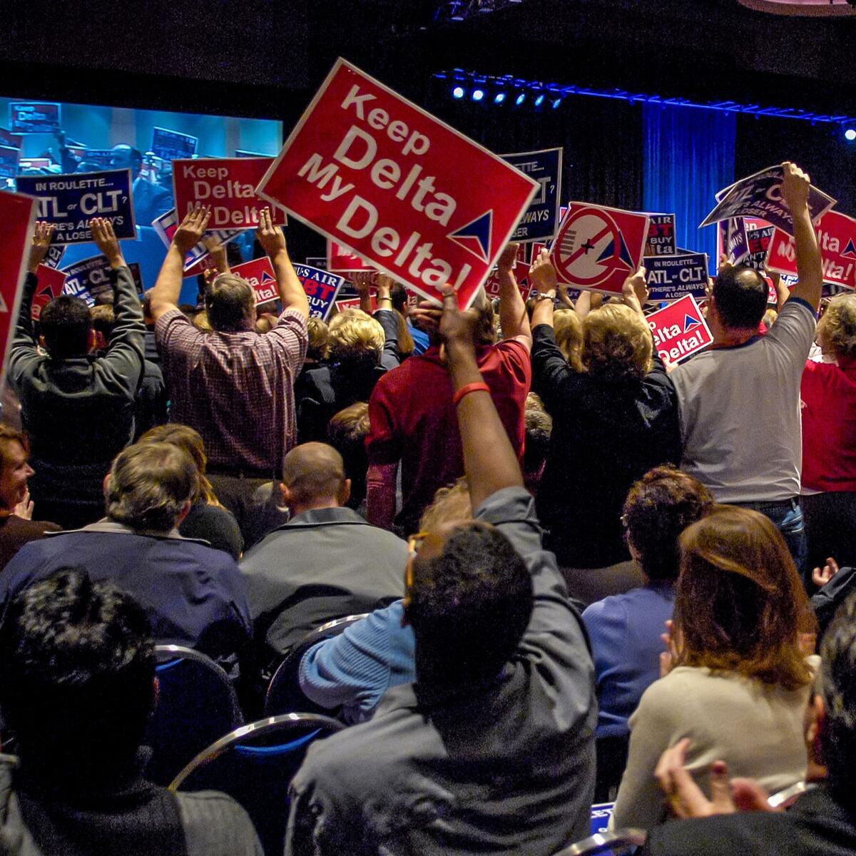 Delta employees and other hold up "Keep Delta My Delta" signs in support of the airline in 2006.