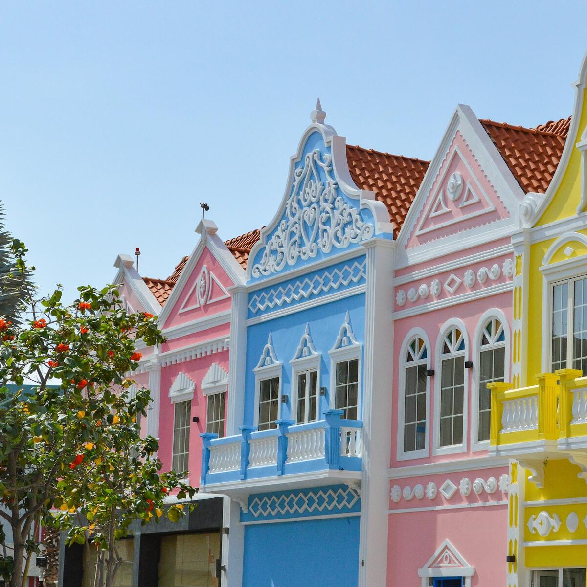 A row of brightly colored houses on a street in Oranjestad, Aruba.