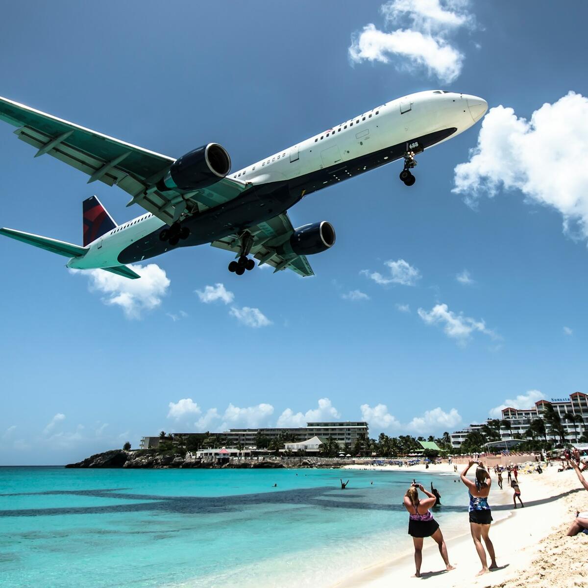 A Delta plane flies over Maho Beach in St. Maarten.