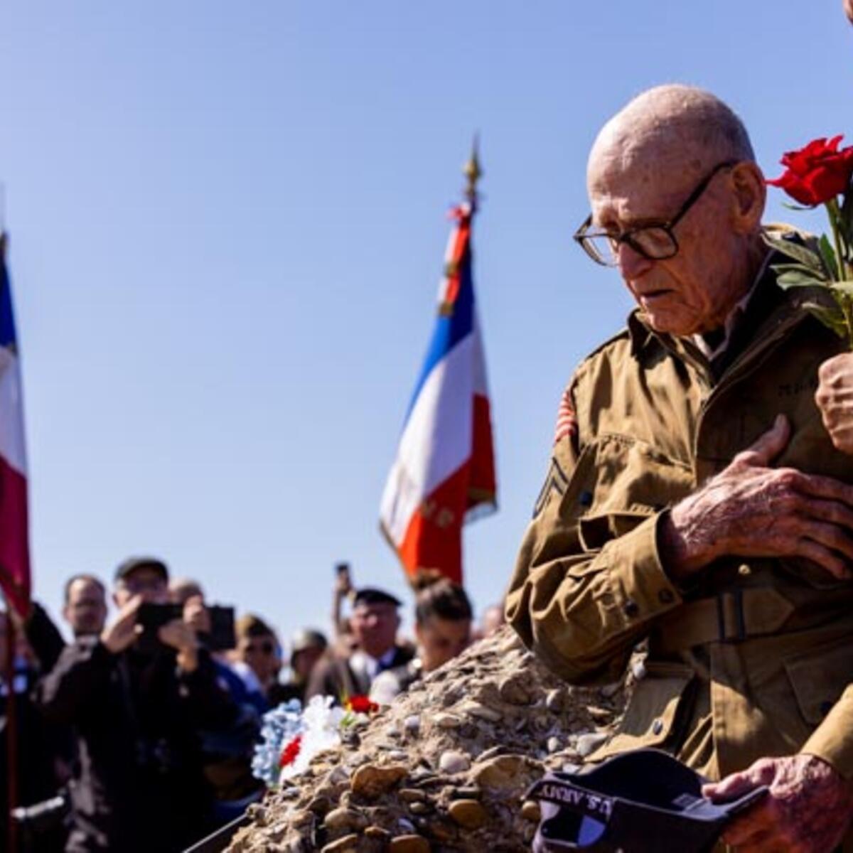 After signing countless autographs, the veterans enjoyed a ride on World War II-era vehicles to Omaha Beach, where they laid roses to remember comrades who lost their lives on those shores.