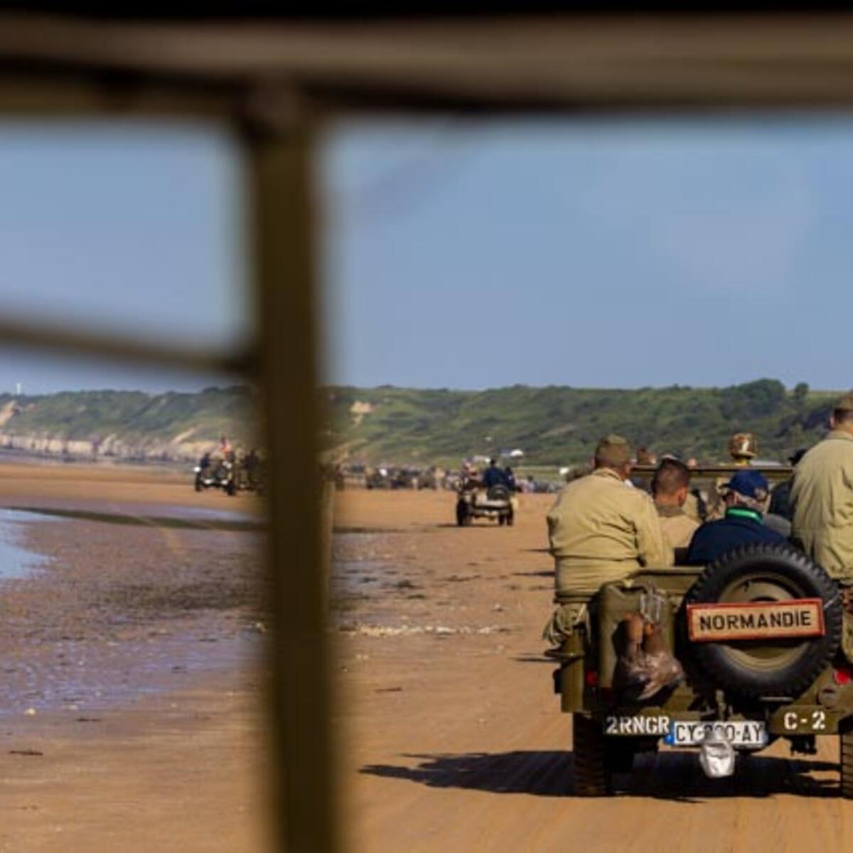 After signing countless autographs, the veterans enjoyed a ride on World War II-era vehicles to Omaha Beach, where they laid roses to remember comrades who lost their lives on those shores.