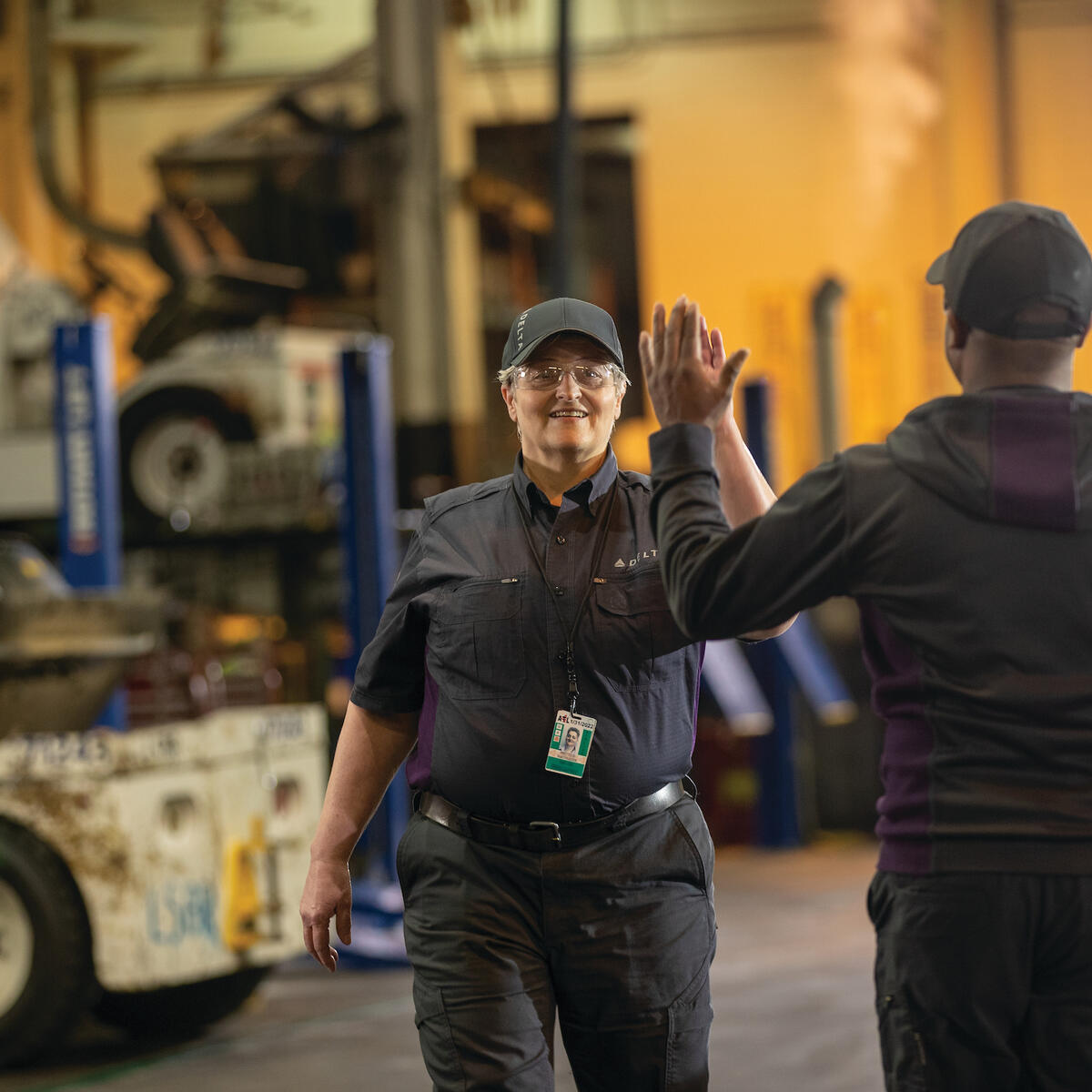 Delta employees high-five at work.