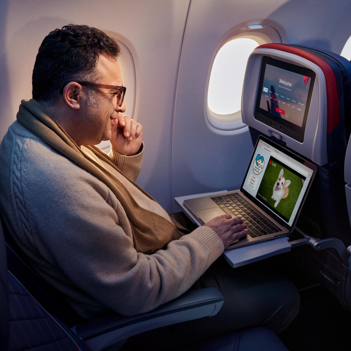 A customer enjoys surfing the web using Delta's fast, free Wi-Fi powered by T-Mobile.