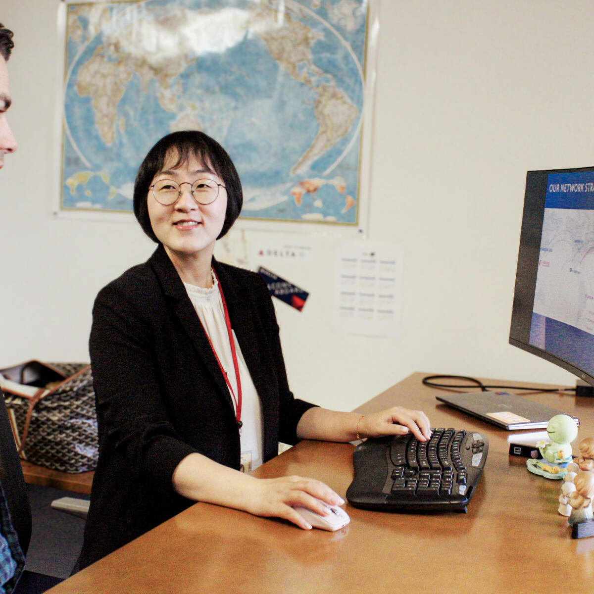Jooyoung Kim, Director – International Network Planning, confers with a colleague.